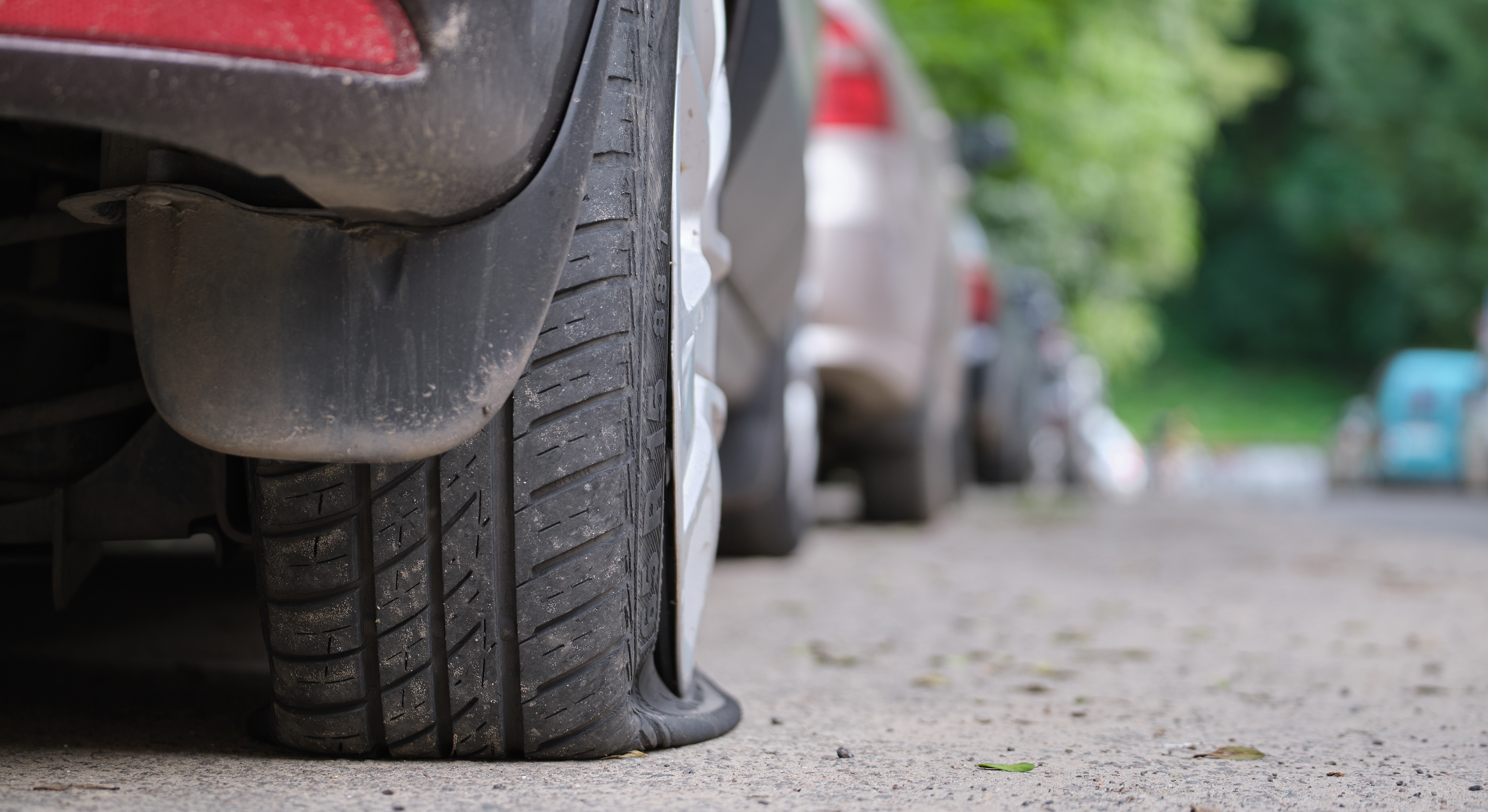 Car with flat tire on roadside